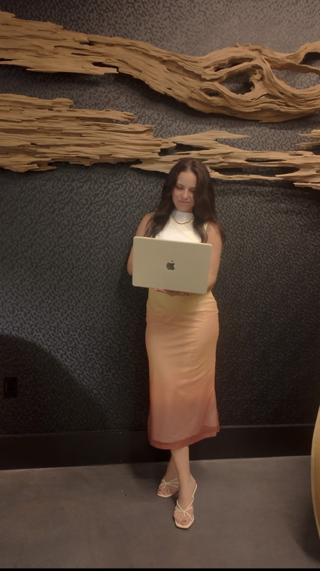 Angelica Marie standing with a laptop